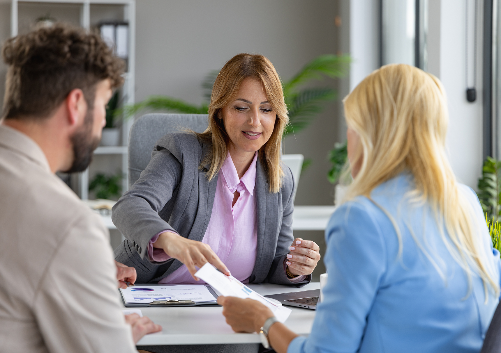 Woman presenting documents to colleagues
