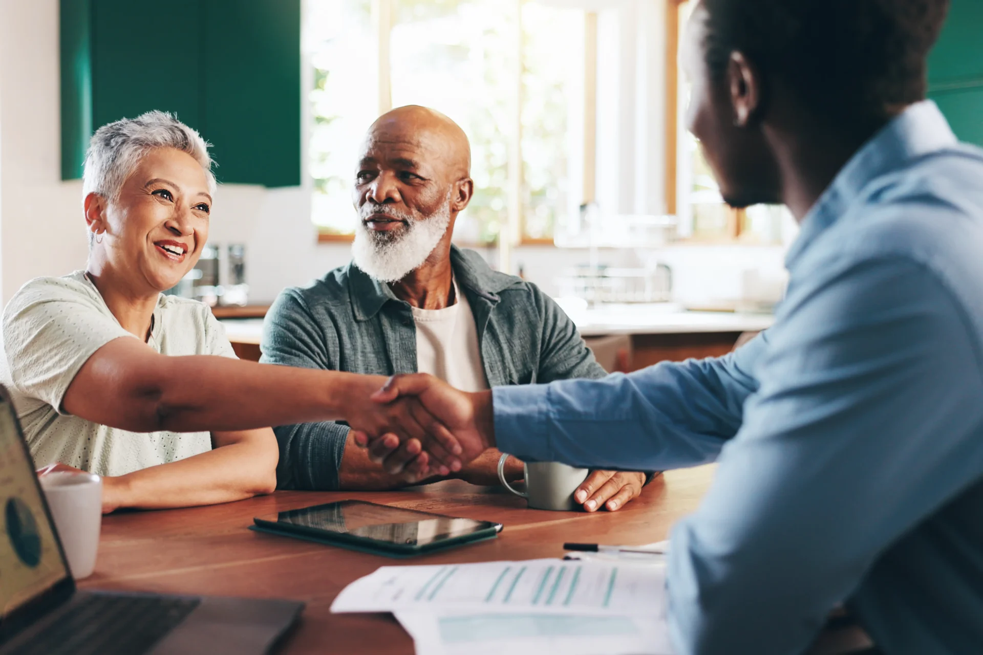 People shaking hands at a business meeting.
