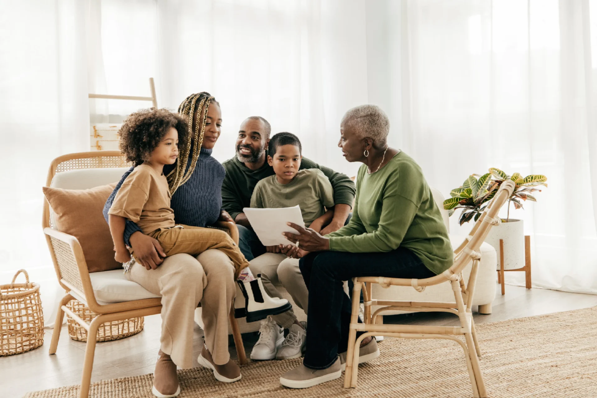Family sitting together, smiling and talking.
