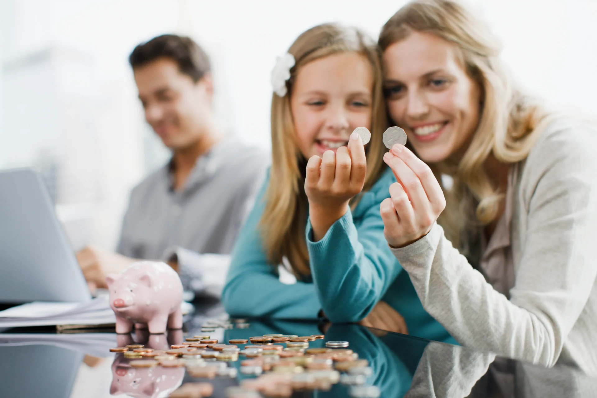 Family saving money with piggy bank.