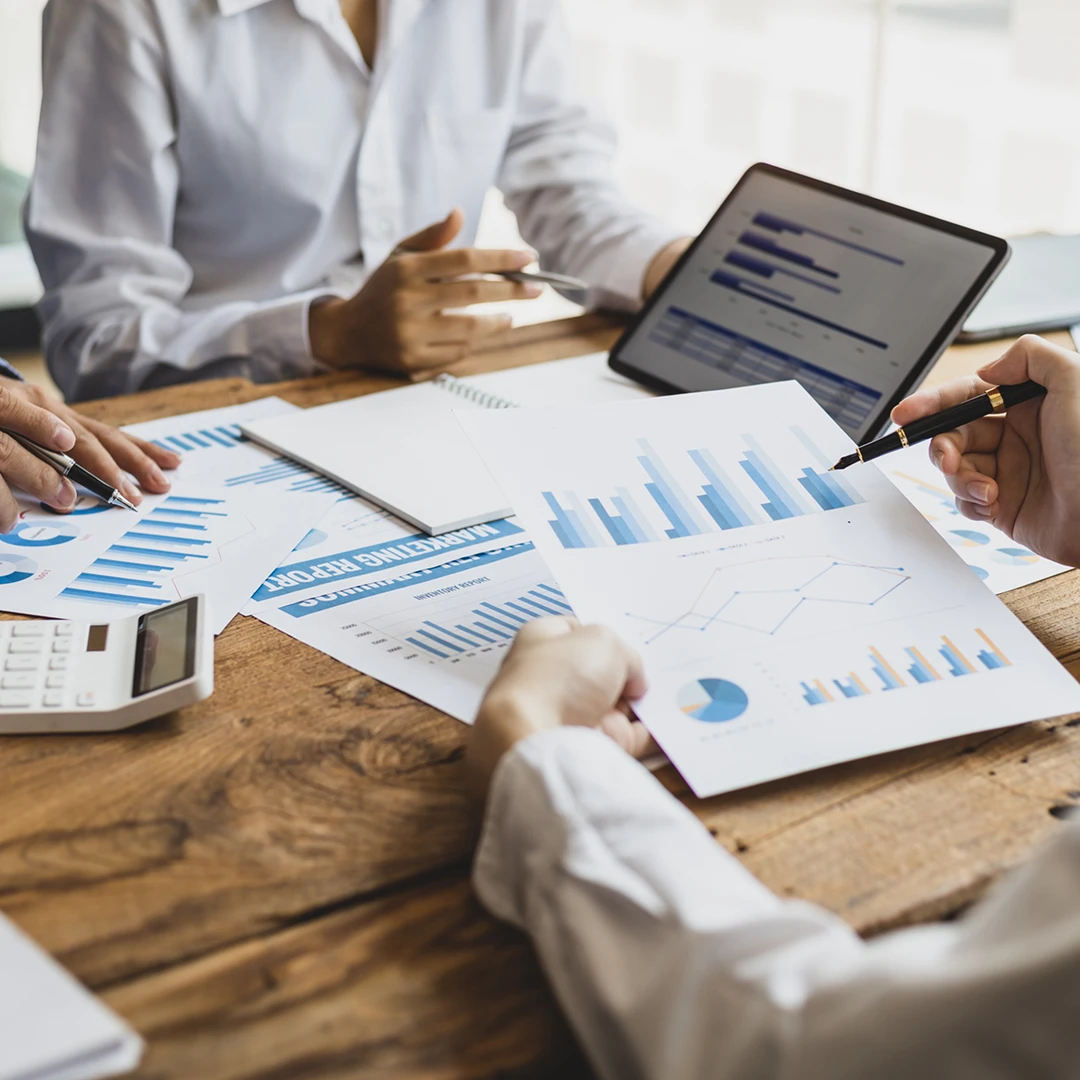 Business meeting with charts and graphs.