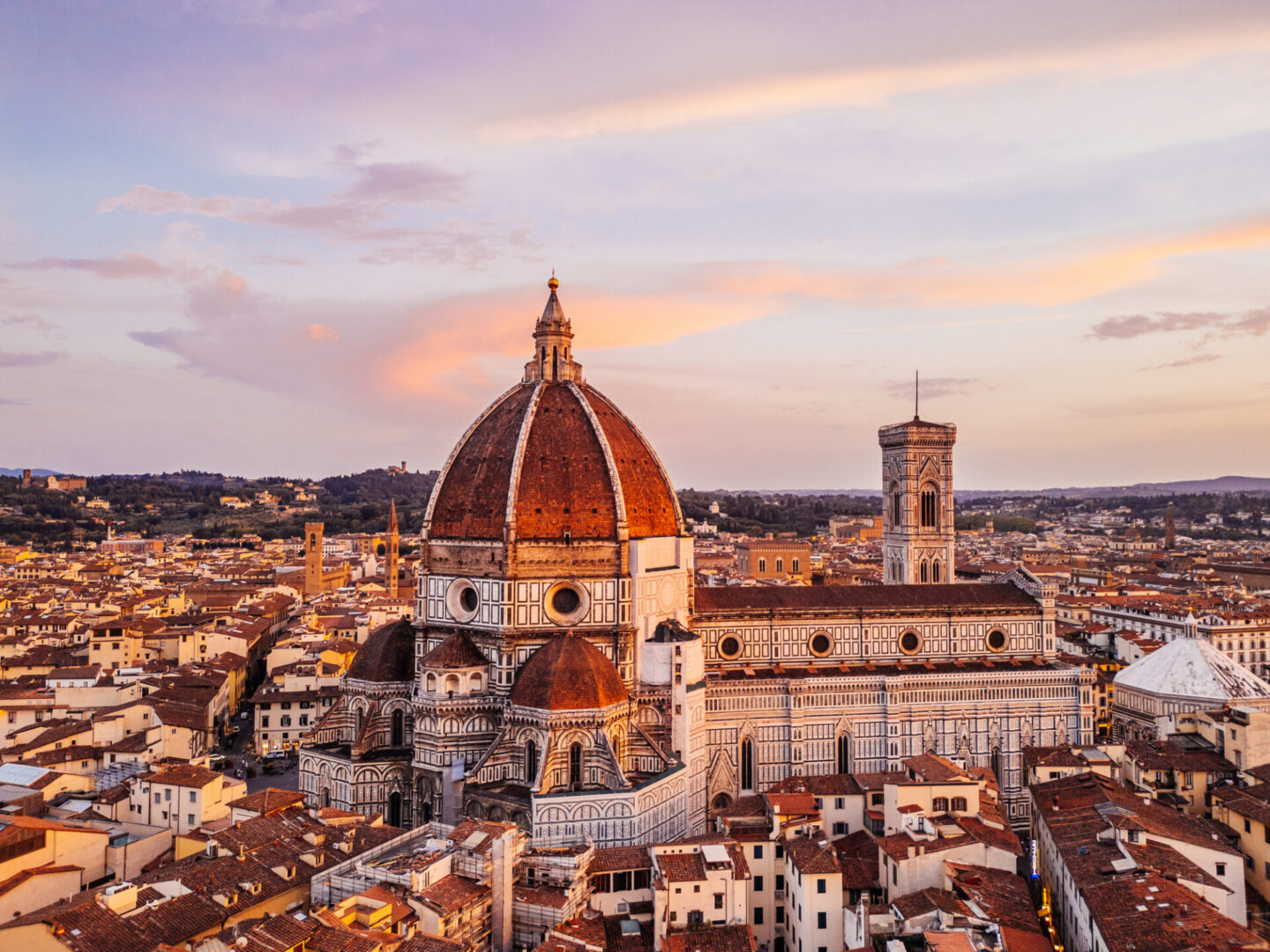 Florence cathedral and giotto's campanile glowing at sunset, tuscany, italy