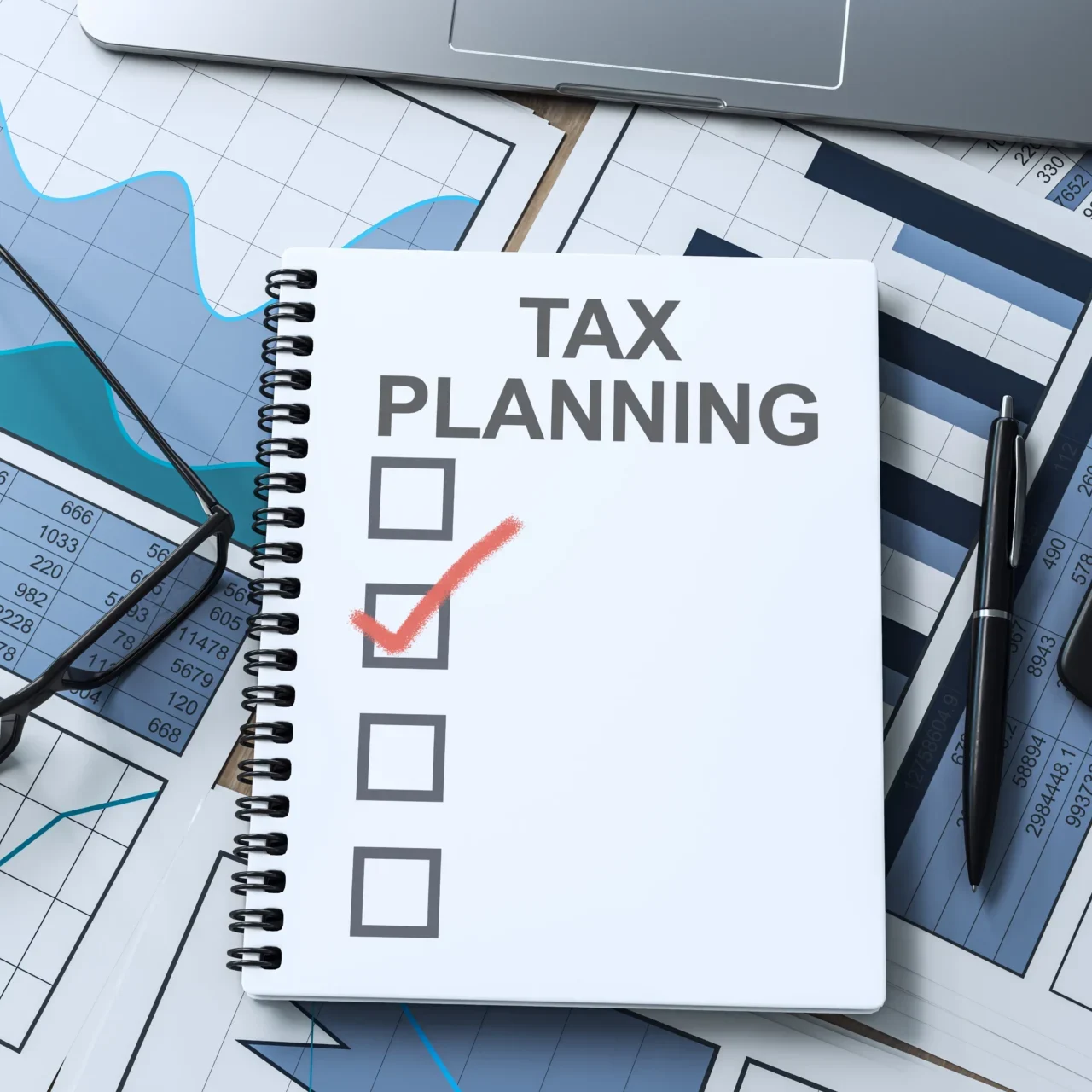 Notebook with "Tax Planning" on financial documents.